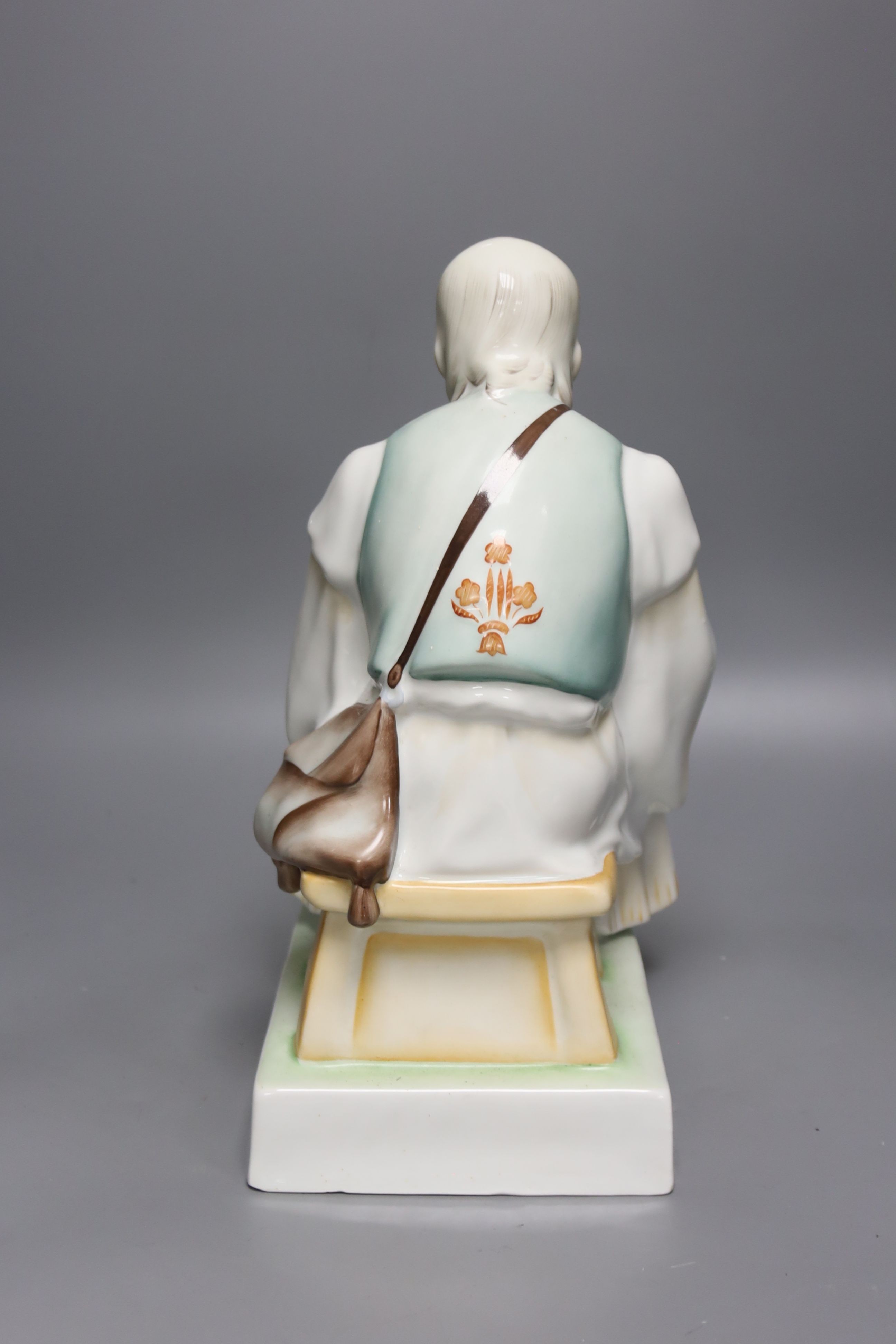 A Zsolnay porcelain figure of a seated peasant, height 33cm